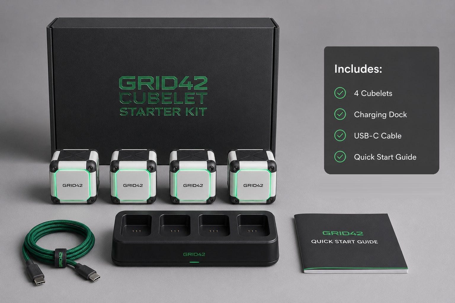 A GRID42 Cubelet starter kit, including cubes, a charging dock, and a cable, in its packaging.